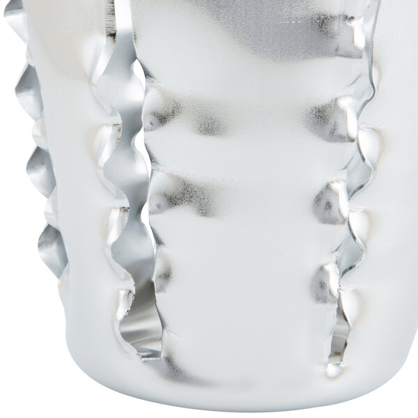 A silver cone-shaped slicer blade with a hole in the end.