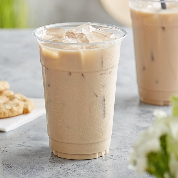 A Tazo Decaf Chai Tea Latte in a cup on a white background.