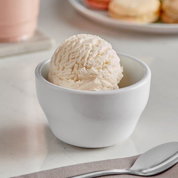 A white bowl with a scoop of Oringer ginger ice cream.