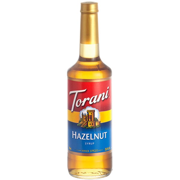 A Torani Hazelnut Flavoring Syrup 750 mL glass bottle with a label.