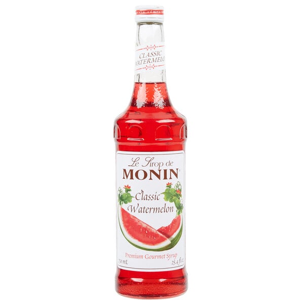 A case of Monin Classic Watermelon Flavoring Syrup with red liquid inside.