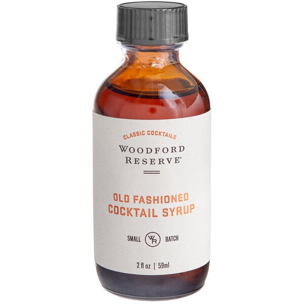 A Woodford Reserve Old Fashioned Syrup bottle on a counter with a white label.
