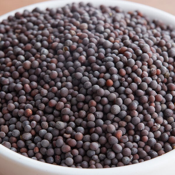 A bowl of brown round Regal Black Mustard Seeds.