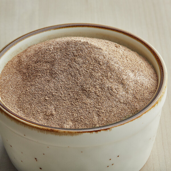 A bowl of Carnival King Salt and Pepper Popcorn Seasoning powder.