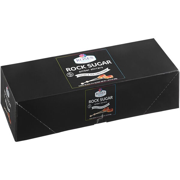 A black box of Roses Dryden and Palmer Amber rock candy barista stirrers with white and blue text.