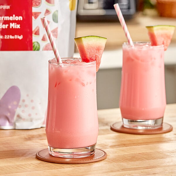 A glass of pink watermelon bubble tea with a straw.