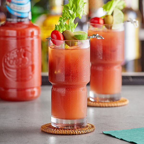 A glass of Finest Call Bloody Caesar Mix on a coaster.