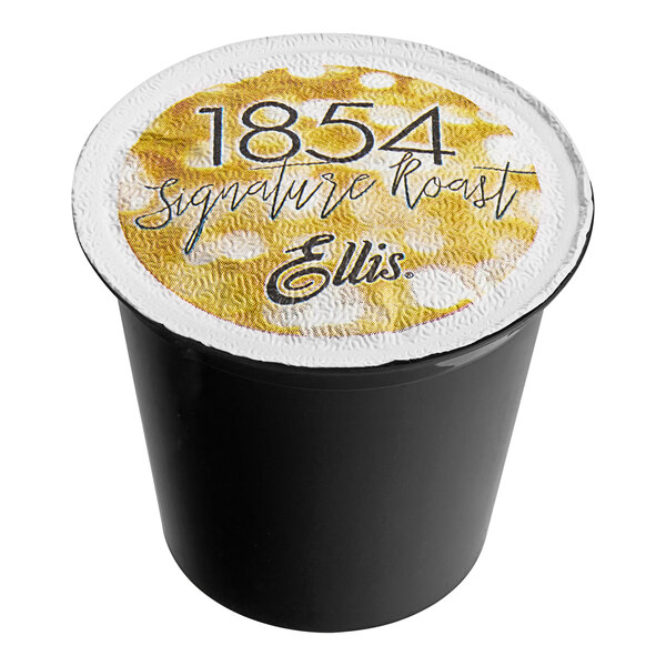 A black Ellis single serve coffee cup with a yellow label and lid with the number 1854.