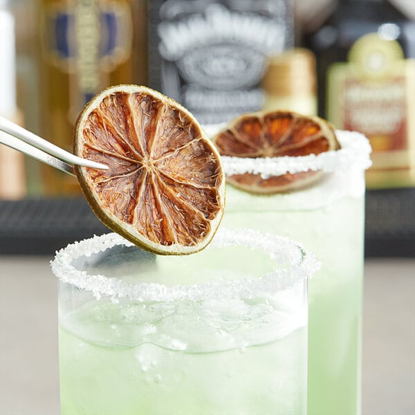 Dried lime slices on a glass of water.