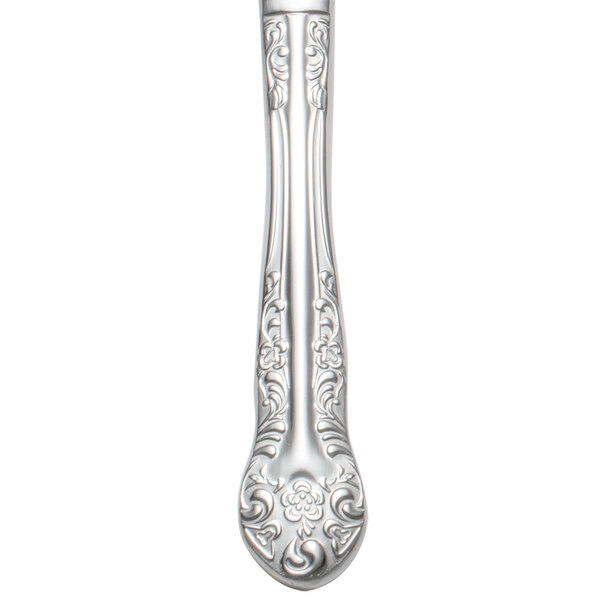 A Oneida Rosewood stainless steel dinner knife with a floral design on the handle.