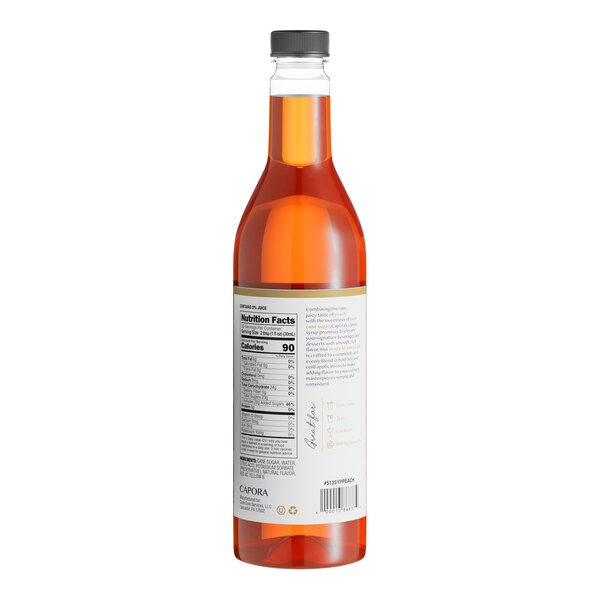 A close up of a bottle of Capora Peach Flavoring Syrup with a label.