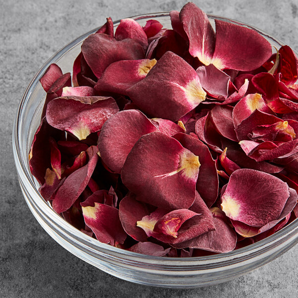 A bowl of Sosa freeze-dried red rose petals on a table.