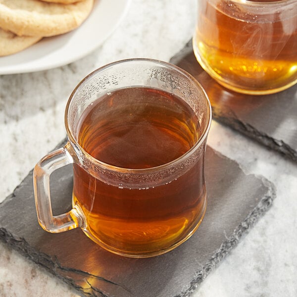 Two Twinings Peppermint tea cups on a stone coaster.