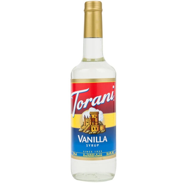 A Torani Vanilla Flavoring Syrup 750 mL glass bottle with a label.