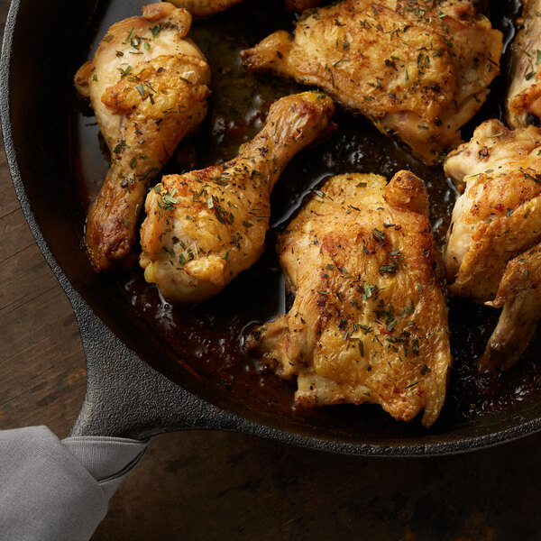 A pan of chicken legs seasoned with Regal Tarragon Leaves.