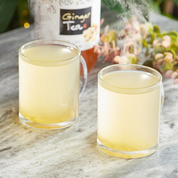 Two cups of Assi Korean Citron Tea on a table.