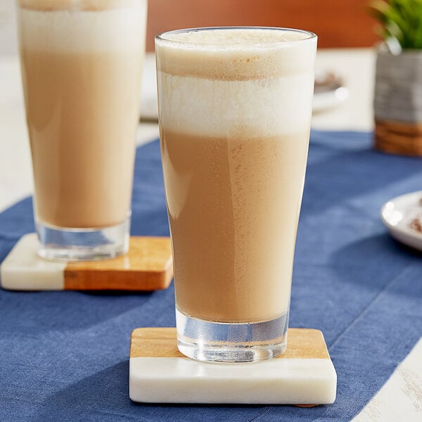Two glasses of DaVinci Gourmet East India Spice coffee on coasters.