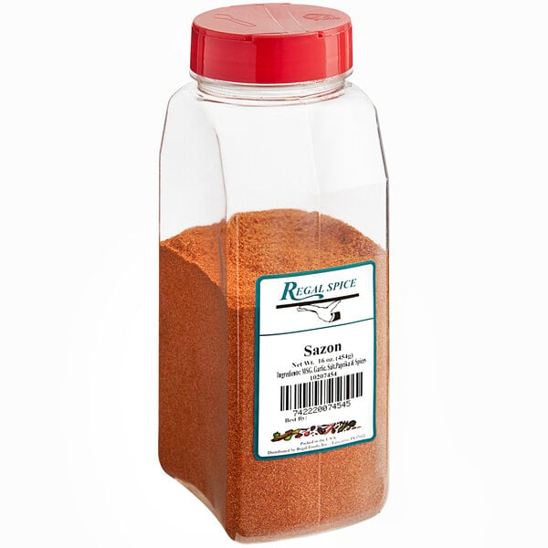 A clear plastic container of brown powder with a red lid.