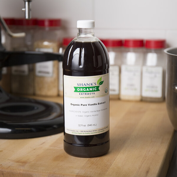 A close-up of a bottle of Shank's Organic Vanilla Extract on a counter.