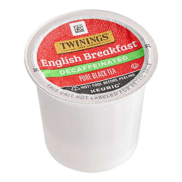 A white plastic container of Twinings English Breakfast Decaffeinated Tea K-Cup Pods with a red and black label.
