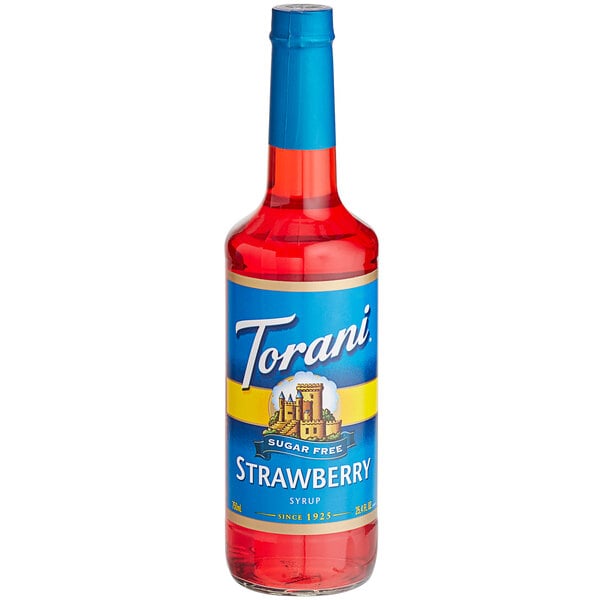 A close-up of a Torani Sugar-Free Strawberry Fruit Syrup bottle with a blue label.