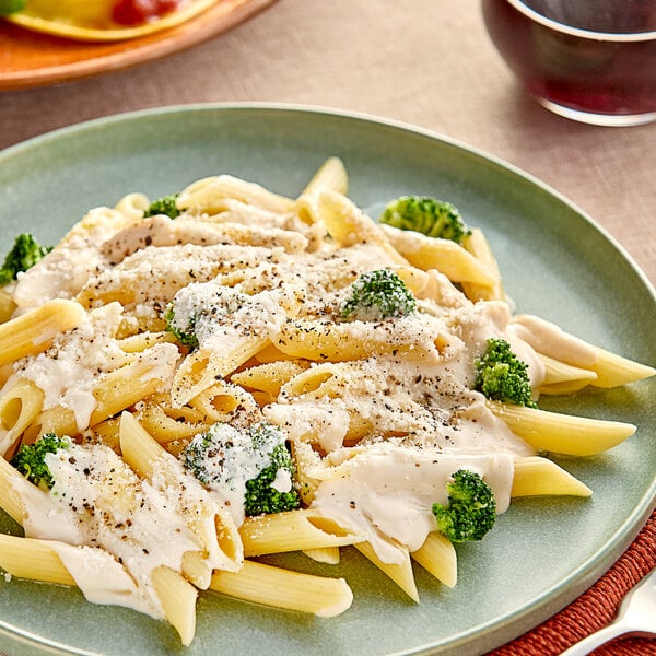 A plate of Seviroli penne pasta with broccoli and cheese sauce.