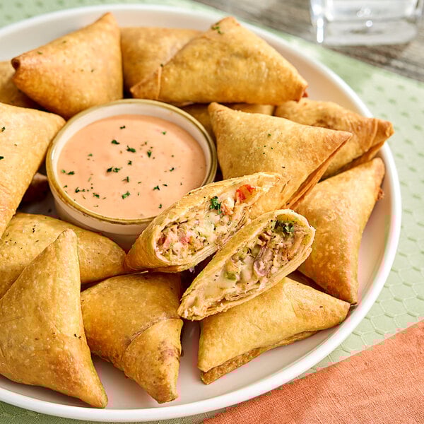 A plate with a Maple Leaf Farms Duck and Pepperjack Quesadilla and dipping sauce.