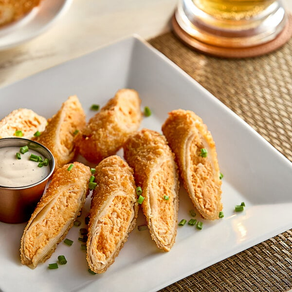 A plate with Crunch Factory Buffalo-Style Chicken Crunch Rolls on it.