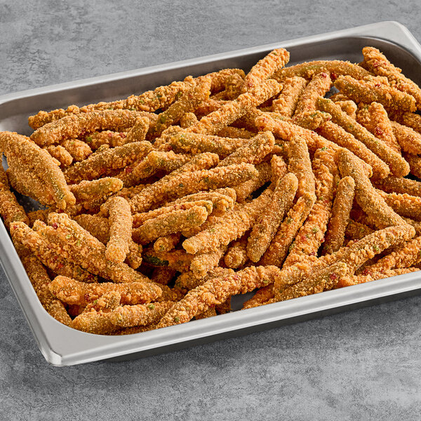 A tray of Fred's Fancy Fries Breaded Spicy Green Beans on a table.