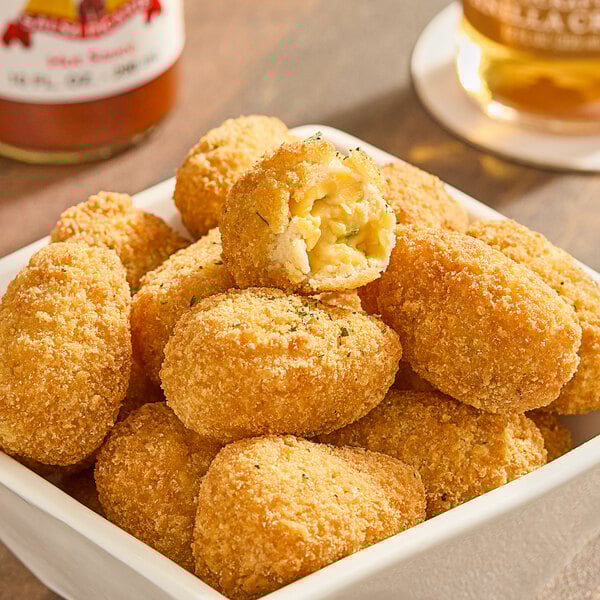 A bowl of Fred's Breaded Jalapeno Cheddar Cheese Bites.