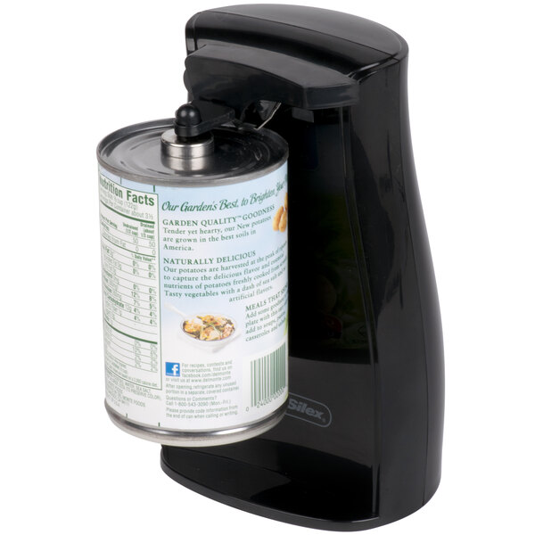 A black Proctor Silex electric can opener opening a can of food.