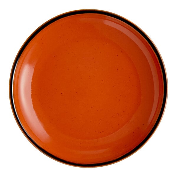A round, orange porcelain coupe plate with a dark rim.