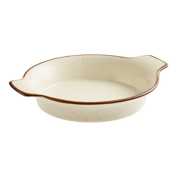A white porcelain shirred egg casserole dish with a brown rim.