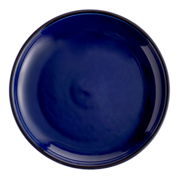 A round, solid blue porcelain coupe plate.