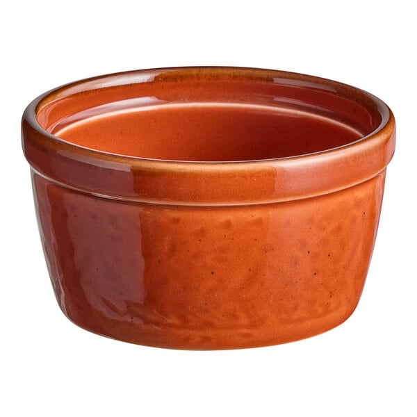 An Acopa Keystone Sedona Orange porcelain ramekin with a white background.