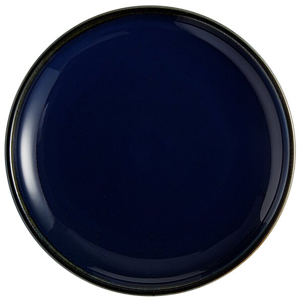 An Acopa Keystone Azora Blue porcelain coupe plate with a black rim.