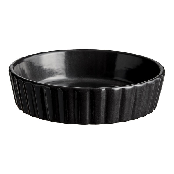 A black round Acopa Keystone porcelain dish with a ribbed rim.