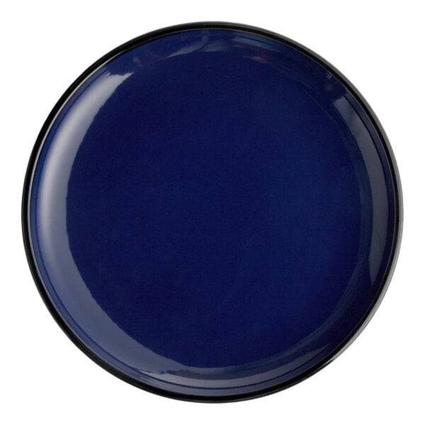A large, round, deep blue porcelain coupe plate.