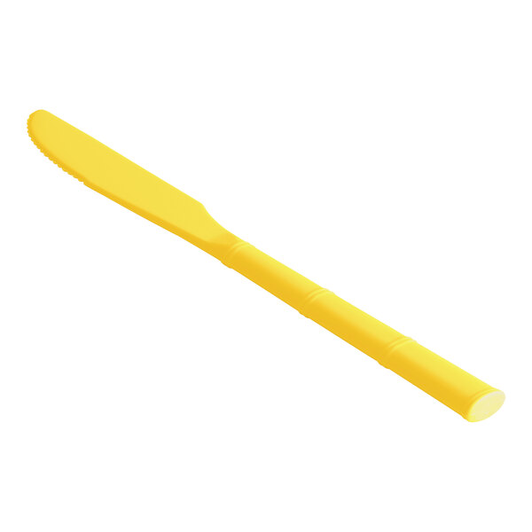 A yellow polycarbonate knife with a white background.