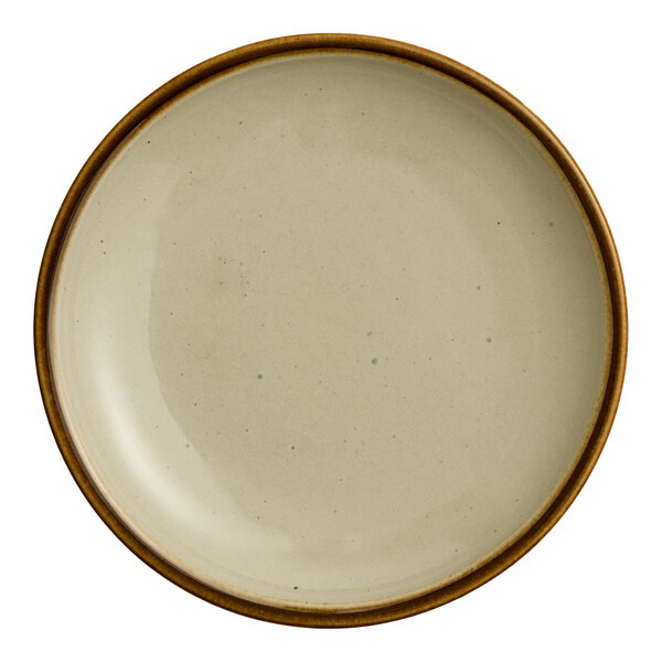 A close-up of an Acopa Keystone granite gray porcelain coupe plate with a white rim.