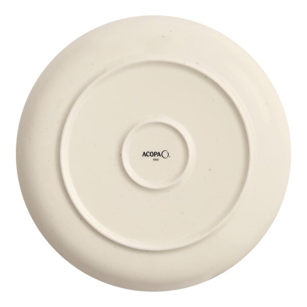 An Acopa Keystone porcelain coupe plate in white with a black circle design.