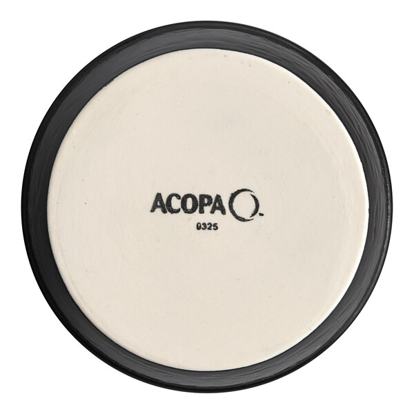 A white Acopa porcelain ramekin with a black rim on a white plate.