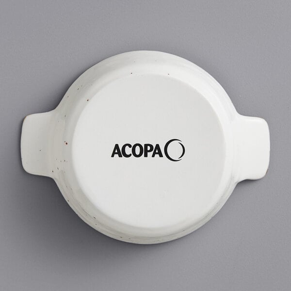 A white porcelain casserole dish with "Acopa" in black text.