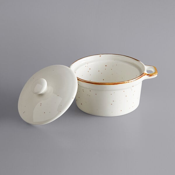 A white porcelain casserole dish with a lid and handle.