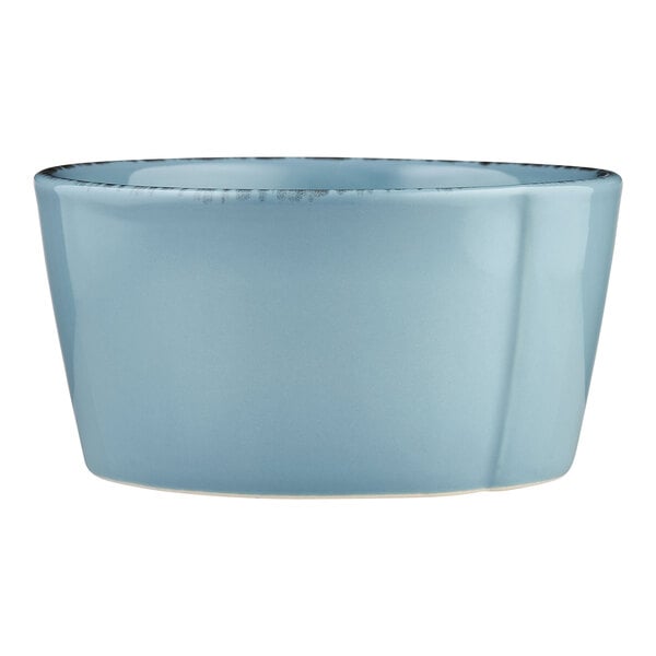 A close-up of a Libbey blue boullion bowl with a black rim.