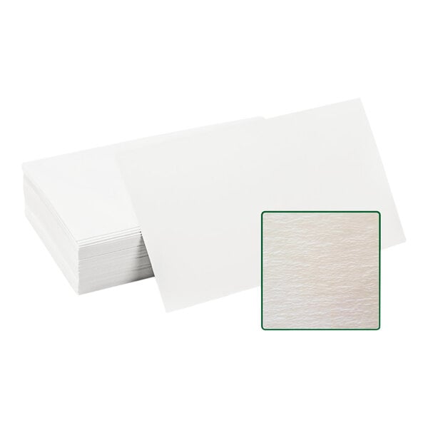 A stack of white flat style filter paper with a green square on the packaging.