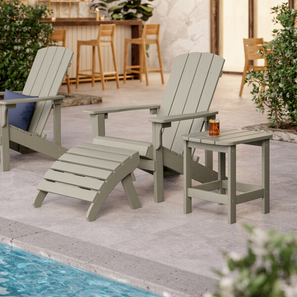 A Lancaster Table & Seating gray Adirondack footrest on an outdoor patio table.