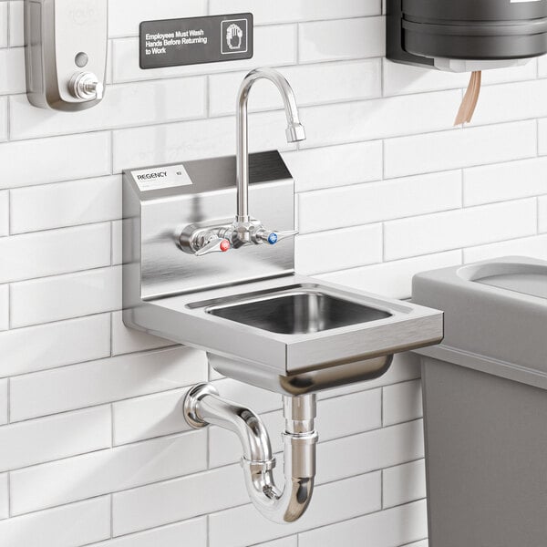 A close-up of a stainless steel wall-mounted hand sink with a T&S faucet.