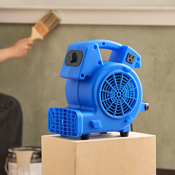 A blue Lavex 3-speed commercial mini air mover placed on a wooden surface.