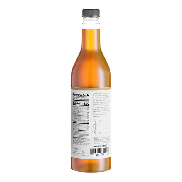 A 750 mL bottle of Capora Mango Flavoring Syrup with a black cap and a nutrition label on the back.